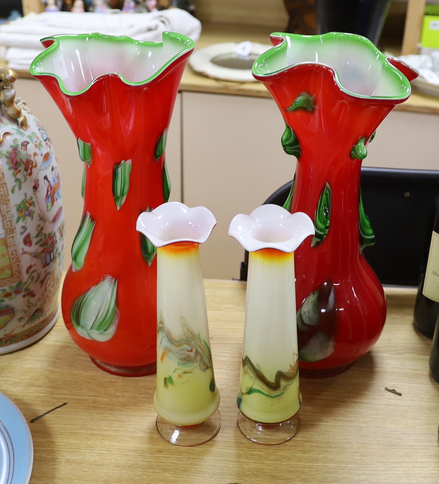 A large pair of Darrius Zarrin red and green glass vases together with another smaller pair of vases, tallest 41cm